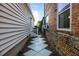 Outdoor side yard with brick and painted siding, a paver walkway, and AC Unit at 78 Nassau St, Charleston, SC 29403