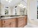 Bathroom vanity with marble countertop, dual sinks, and elegant lighting at 87 Dungannon Hall, Kiawah Island, SC 29455