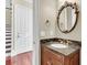 Elegant powder room with a marble countertop and decorative mirror at 87 Dungannon Hall, Kiawah Island, SC 29455