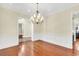 Dining area featuring a chandelier, wainscoting and hardwood floors at 87 Dungannon Hall, Kiawah Island, SC 29455