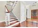 Elegant foyer with hardwood floors, staircase, and a grand entryway door at 87 Dungannon Hall, Kiawah Island, SC 29455