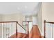Second story hallway with hardwood floors and stairs at 87 Dungannon Hall, Kiawah Island, SC 29455
