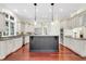 Open kitchen with granite countertops, stainless steel appliances and a large center island and dark cabinets at 87 Dungannon Hall, Kiawah Island, SC 29455