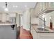 Bright kitchen featuring granite countertops, stainless steel refrigerator and view into the dining and living areas at 87 Dungannon Hall, Kiawah Island, SC 29455