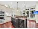 Spacious kitchen with granite countertops, stainless steel appliances, and ample natural light from surrounding windows at 87 Dungannon Hall, Kiawah Island, SC 29455
