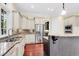 Kitchen with stainless steel refrigerator, tile backsplash, granite countertops and ample storage space at 87 Dungannon Hall, Kiawah Island, SC 29455