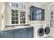 Functional laundry room featuring custom cabinets and modern washer/dryer at 87 Dungannon Hall, Kiawah Island, SC 29455