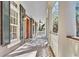 Covered porch with traditional columns, wood flooring, and decorative sconces at 87 Dungannon Hall, Kiawah Island, SC 29455