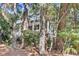 Charming home with a multi-level deck surrounded by lush landscaping and mature trees at 87 Dungannon Hall, Kiawah Island, SC 29455