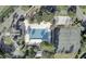 Aerial view of a well-maintained community pool, tennis court, and recreational area surrounded by greenery at 914 Tupelo Bay Dr, Mount Pleasant, SC 29464