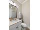 Neutral toned bathroom with white vanity, framed mirror, toilet, and shower with leaf-patterned curtain at 914 Tupelo Bay Dr, Mount Pleasant, SC 29464
