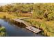 Dock with stairs on the marsh with a person sitting on the edge of the main part of the dock and trees in the background at 914 Tupelo Bay Dr, Mount Pleasant, SC 29464