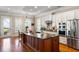 Bright kitchen with a large island, white cabinets, stainless steel appliances and hardwood floors at 914 Tupelo Bay Dr, Mount Pleasant, SC 29464