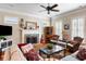 Inviting living room with a brick fireplace, wooden floors, ceiling fan and comfortable seating arrangement at 914 Tupelo Bay Dr, Mount Pleasant, SC 29464