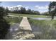 A wooden dock extends into a tranquil marsh, offering a serene waterfront experience surrounded by lush vegetation at 914 Tupelo Bay Dr, Mount Pleasant, SC 29464