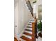 Elegant staircase with stained wood railing and black iron balusters at 914 Tupelo Bay Dr, Mount Pleasant, SC 29464