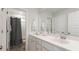 Clean bathroom with a white vanity, a large mirror, and a shower with a gray shower curtain at 1016 Swamp Rose Run, Summerville, SC 29485