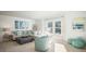 Bright and airy living room featuring a sectional sofa, ottoman, and coastal-inspired decorations at 1016 Swamp Rose Run, Summerville, SC 29485