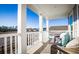 Relaxing front porch with wicker furniture, columns, and a picturesque neighborhood view at 1016 Swamp Rose Run, Summerville, SC 29485