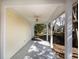 Covered back porch with tile flooring, white columns, and a peaceful view of the backyard at 1051 Wayfarer Ln, Charleston, SC 29412