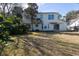 A view of the home's spacious backyard with established trees and partial shade at 1051 Wayfarer Ln, Charleston, SC 29412