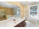 Bathroom features a large vanity with a marble top, a soaking tub, and wallpaper at 1051 Wayfarer Ln, Charleston, SC 29412