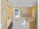 Bathroom features a large vanity with a marble top, a soaking tub, and wallpaper at 1051 Wayfarer Ln, Charleston, SC 29412