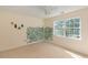 Bedroom features a large window and neutral colored walls with floral decor at 1051 Wayfarer Ln, Charleston, SC 29412