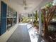 Covered front porch with tile flooring, ceiling fan, and well-maintained landscaping at 1051 Wayfarer Ln, Charleston, SC 29412