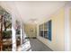 Covered front porch with tile flooring, white columns, ceiling fan, and blue shutters at 1051 Wayfarer Ln, Charleston, SC 29412