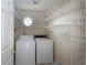 Laundry room with washer, dryer, octagon window, and wire shelving for ample storage at 1051 Wayfarer Ln, Charleston, SC 29412