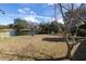 A grassy backyard features a pond with surrounding trees and a clear blue sky at 1051 Wayfarer Ln, Charleston, SC 29412