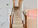 Carpeted staircase with wooden railing and view of living room at 1051 Wayfarer Ln, Charleston, SC 29412