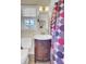 Bathroom features a vanity sink, a toilet, a window with blinds, and a colorful polka dot shower curtain at 108 Gambels Ln, Summerville, SC 29485