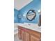 Bright blue bathroom featuring a wood vanity, sink, mirror, and decorative lighting at 108 Gambels Ln, Summerville, SC 29485