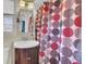 Cozy bathroom featuring a wood vanity, a sink, a mirror, and a colorful patterned shower curtain at 108 Gambels Ln, Summerville, SC 29485
