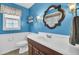 Bathroom featuring a framed mirror, blue walls, white trim, towel rack, and vanity at 108 Gambels Ln, Summerville, SC 29485