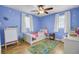 Brightly painted bedroom featuring a ceiling fan, white trim, and a themed rug at 108 Gambels Ln, Summerville, SC 29485