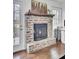 Charming brick fireplace with wooden mantle, adjacent to a bright home office space at 108 Gambels Ln, Summerville, SC 29485