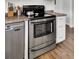 Stainless steel oven and dishwasher with white cabinets in an updated kitchen at 108 Gambels Ln, Summerville, SC 29485