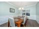 Light-filled dining room featuring modern wainscoting, statement light fixture and views to the rear yard at 1089 Fort Johnson Rd, Charleston, SC 29412