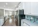 Chef-style kitchen featuring sleek appliances, light countertops and backsplash, and ample storage at 1089 Fort Johnson Rd, Charleston, SC 29412