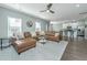 Spacious living room with a comfortable leather sectional, an open floor plan, and abundant natural light at 1089 Fort Johnson Rd, Charleston, SC 29412