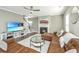 Bright living room featuring a fireplace, a leather sofa, and a large flat-screen TV for entertainment at 1089 Fort Johnson Rd, Charleston, SC 29412