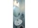 Bright powder room featuring a round mirror, pedestal sink, and modern chrome light fixture at 1089 Fort Johnson Rd, Charleston, SC 29412