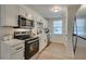 Well-lit kitchen featuring stainless steel appliances, white cabinets, and modern countertops at 109 Gerideau St, Walterboro, SC 29488