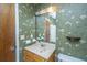 Bathroom with decorative floral wallpaper, vanity, and large mirror at 113 Kennington Dr, Goose Creek, SC 29445