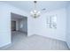 Well-lit dining room with neutral carpet, classic chandelier, and large windows offering bright natural light at 113 Kennington Dr, Goose Creek, SC 29445