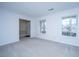 Spacious living room featuring carpet, large windows offering natural light, and an open doorway at 113 Kennington Dr, Goose Creek, SC 29445