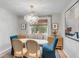 Dining area with a modern chandelier, table, and chairs and natural light from the large window at 1174 Village Creek Ln # 3, Mount Pleasant, SC 29464